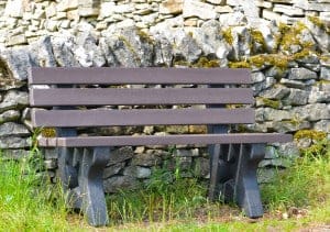 Recycled plastic Peak bench in front of dry stone wall