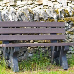 Recycled plastic Peak bench in front of dry stone wall