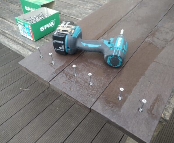 Screws being drilled into raised bed
