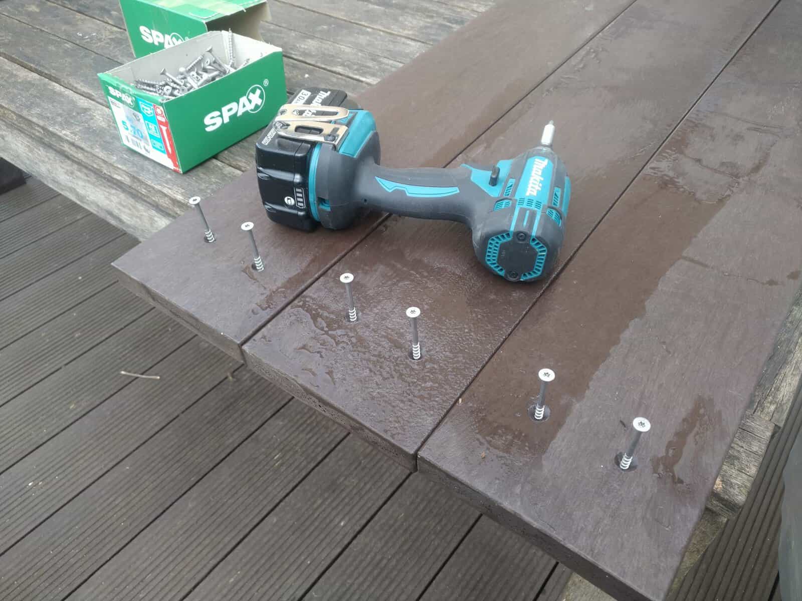 Screws being drilled into raised bed