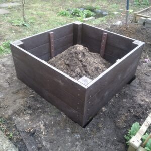 Flat pack raised bed being installed