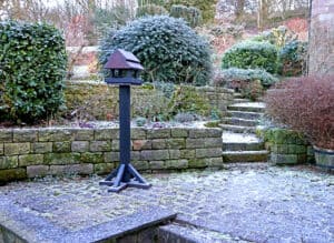 TDP Improved Recycled Bird Feeding Station in Brown, placed in a winter garden